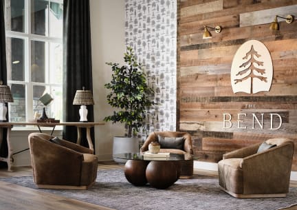 a living room with a grey couch and two coffee tables
