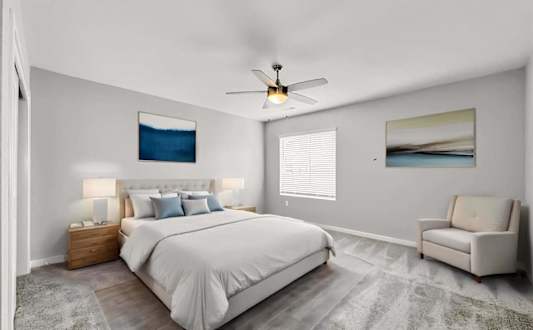 A modern living room with a white sofa, a round coffee table, and a large abstract wall art.