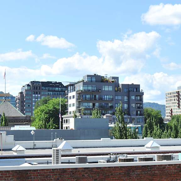 A cityscape with buildings and a clear sky.