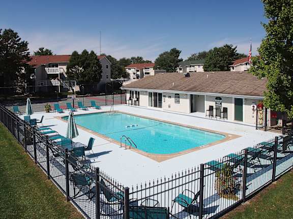 A black fence surrounds a small pool.