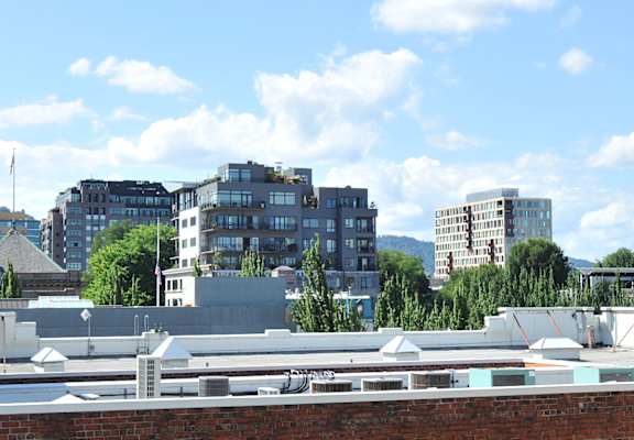 A cityscape with buildings and a clear sky.