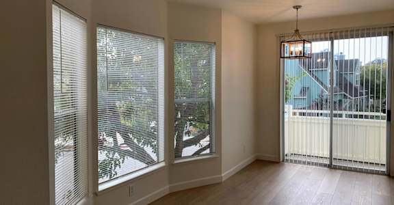 A room with a sliding glass door leading to a balcony. at Westmont Place Townhomes Apartments, Santa Cruz