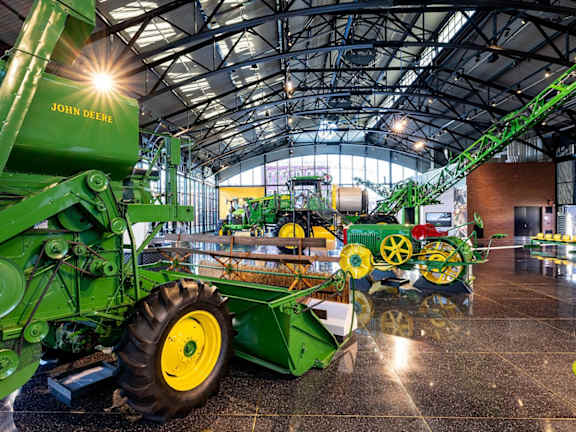 A John Deere tractor is on display in a showroom. at Kimberly Club Apartments, Davenport, 52807