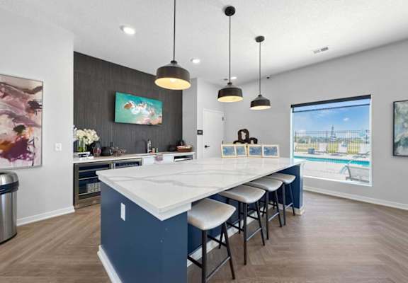 A kitchen with a granite countertop and a refrigerator.
