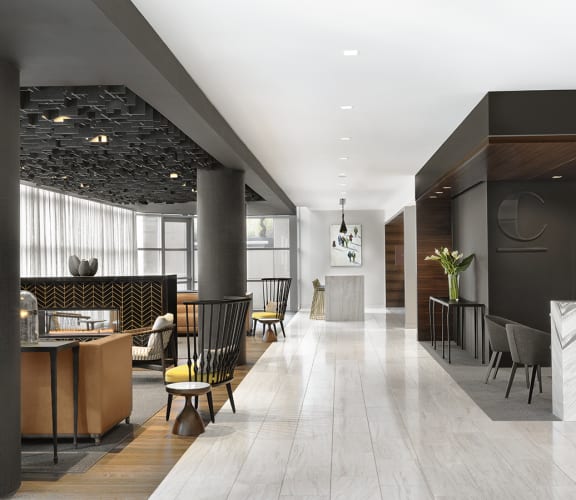 Lobby with marble flooring, conversational seating and dark finishes  at Clayton On The Park, Missouri, 63105
