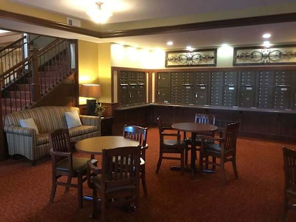 A room with a table and chairs and a couch.