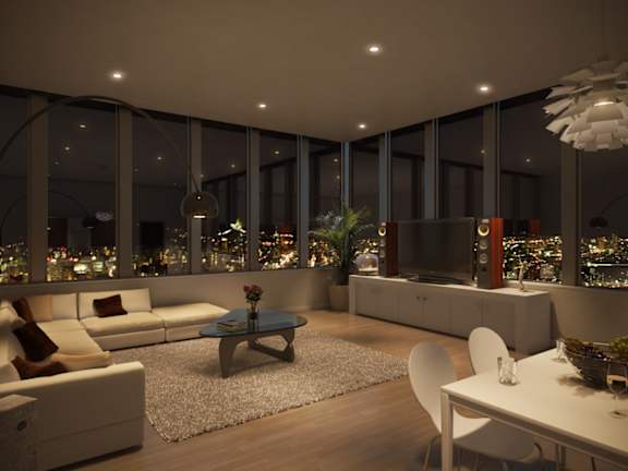 A modern living room with a view of the city at night.