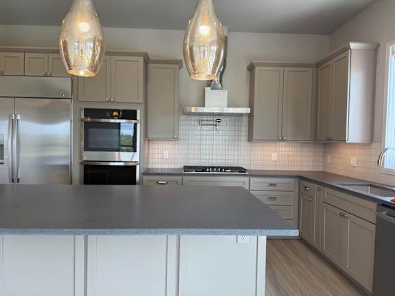 A kitchen with a stove top oven and a microwave.