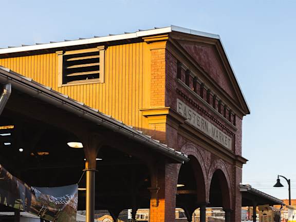 A building with a sign that says "Eastern Market" on it.