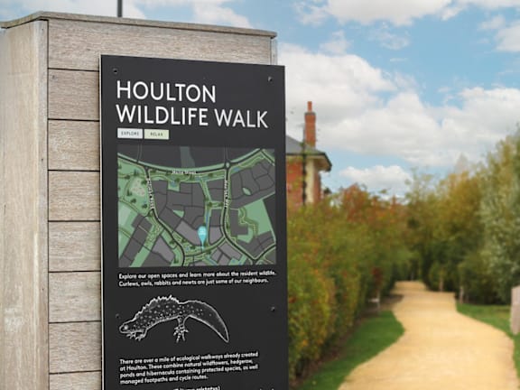 a sign for a wildlife walk on a path