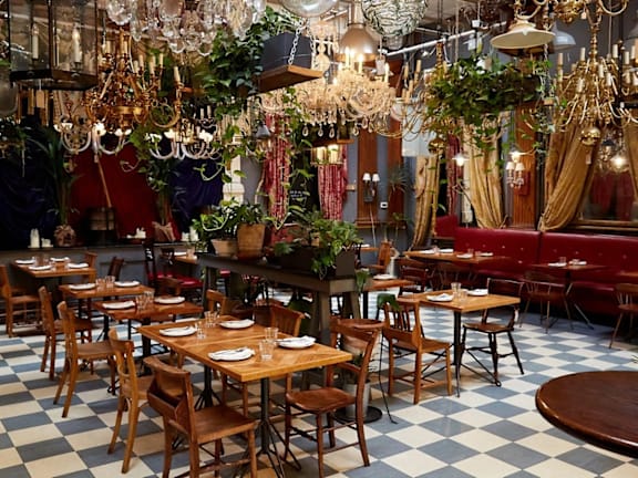 a restaurant with a checkered floor and many tables