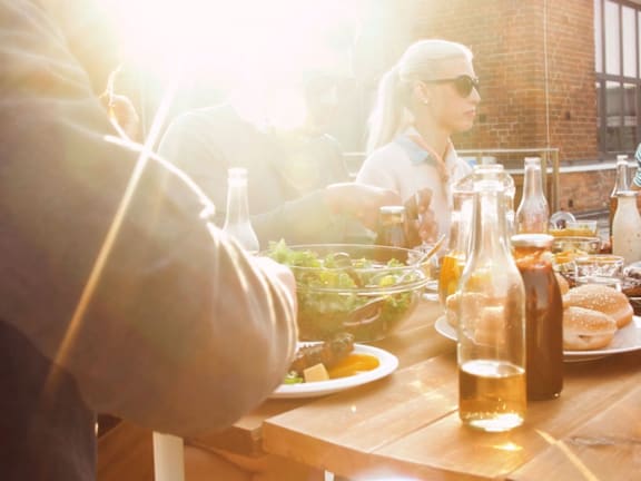 people eating food at a table in a restaurant