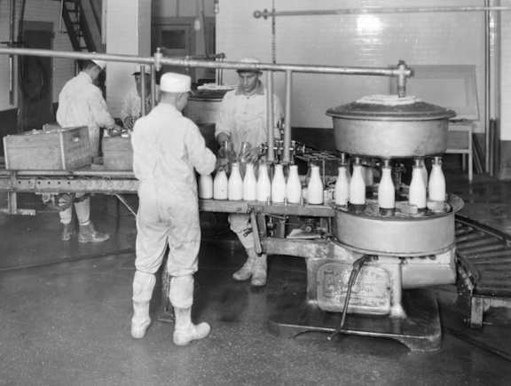 A black and white photo of workers in a factory.