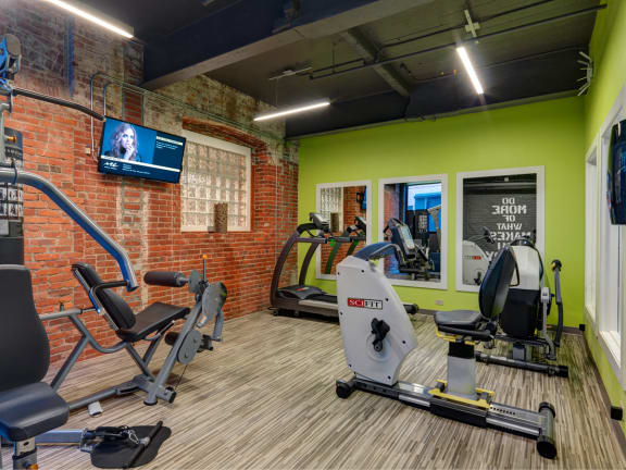 Fitness Center Equipment and TV at Robinson Cuticura Mill Apartments in Malden , MA.