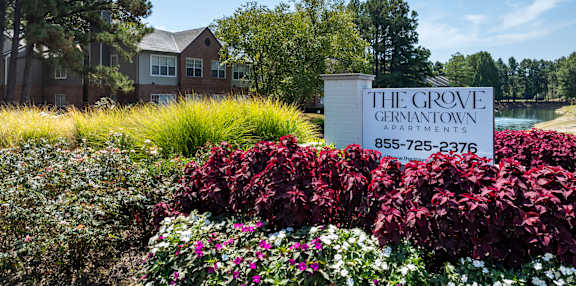 the grove convention center sign in front of flowers and plants