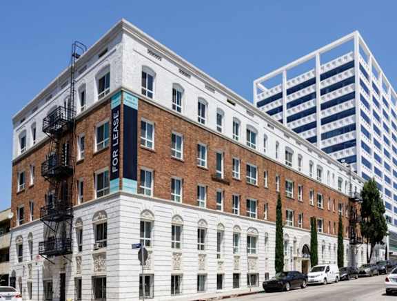 A white building with a black fire escape on the side.