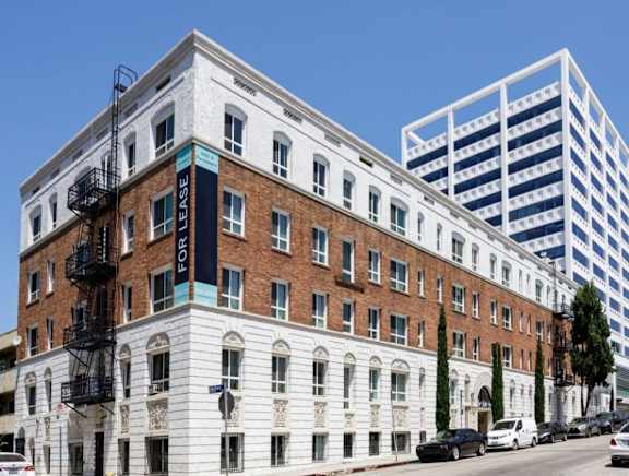 A white building with a black fire escape on the side.