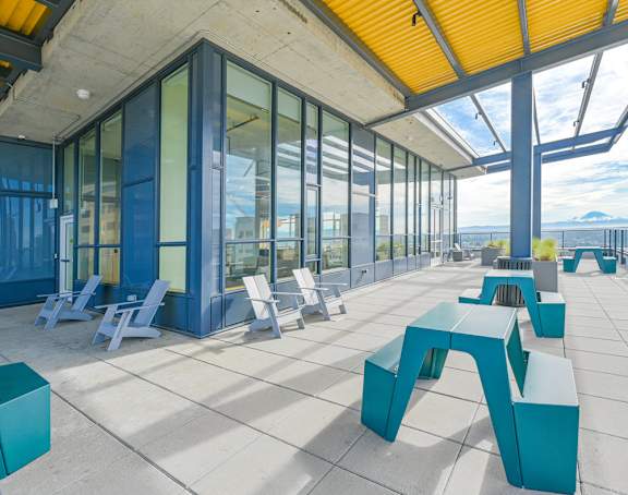 A modern outdoor seating area with blue and white furniture.