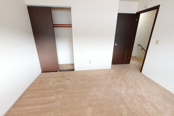 Bedroom with carpet and a sliding door closet