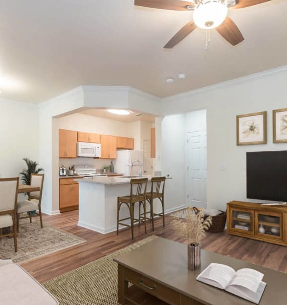 a living room with a kitchen and a table with chairs at Woodway Village, Austin, TX 78744