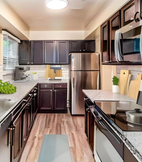 a kitchen with stainless steel appliances and marble counter tops at Olde Towne in Kenwood, Cincinnati, OH, 45243