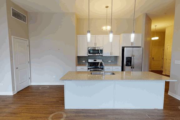 A kitchen with a countertop and cabinets is shown.