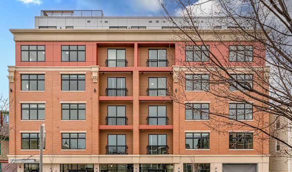 a large brick building with a parking garage in front of itat Union 346, Somerville
