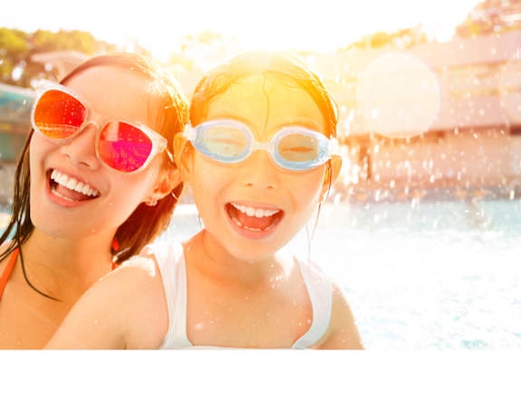 a mother and daughter wearing sunglasses in a pool
