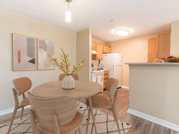 A kitchen with wooden floors and a granite countertop.