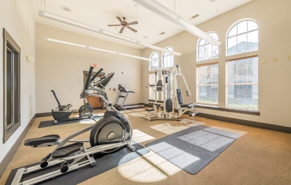 a home gym with exercise equipment and windows at Mission at Baytown, Baytown Texas