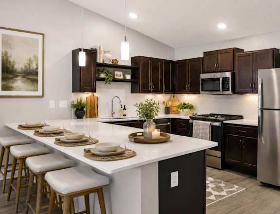 A modern kitchen with a white island and dark brown cabinets.