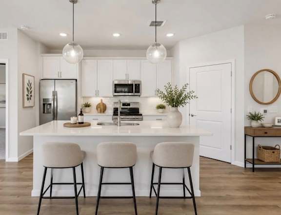 A modern kitchen with white cabinets and a central island.