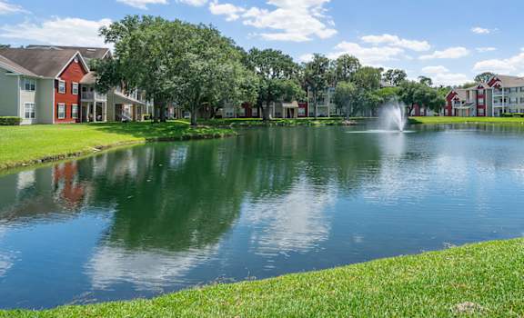 a pond with a fountain in front of some apartments at Bella Vista on Park, Florida, 33563