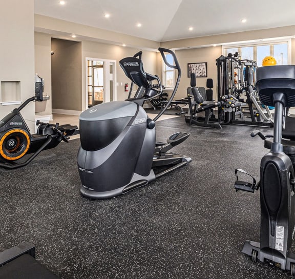 a gym with treadmills and other exercise equipment in a large space  at Signature Pointe Apartment Homes, Athens, 35611