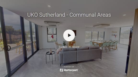 a living area with a couch and a table in a living room