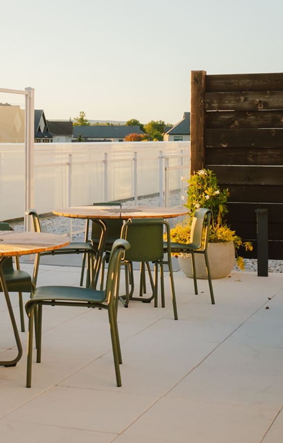 A patio with a table and chairs.