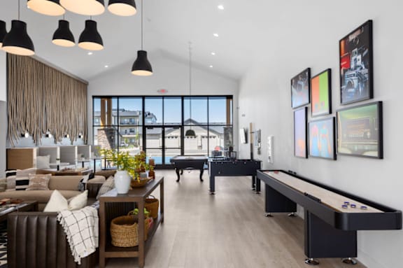 a living room with a foosball table and a large window