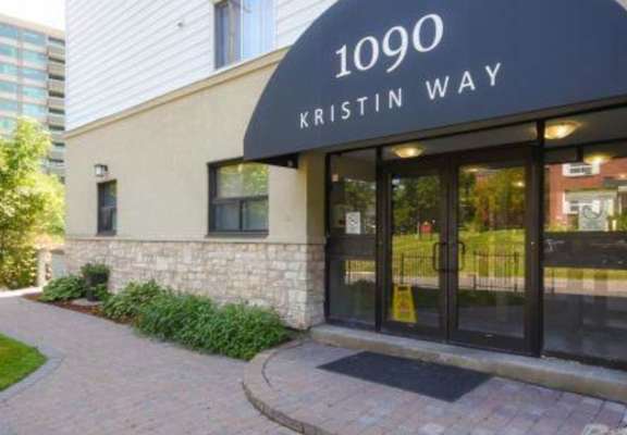 a building with a black awning and the words 1009 kristin way