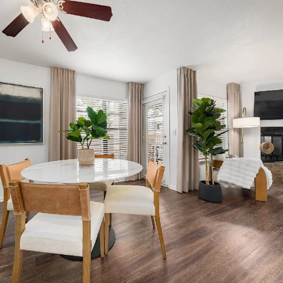 A modern dining room with a round table and chairs.