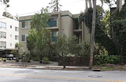 an apartment building on the corner of a street