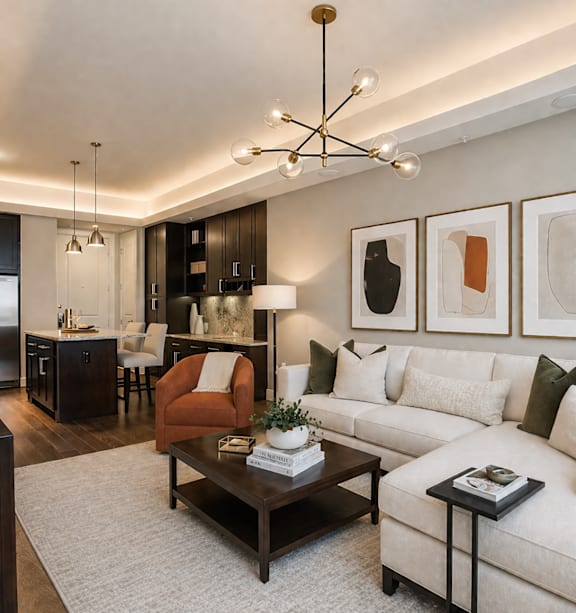 A modern living room with a white couch, a coffee table, and a chandelier.