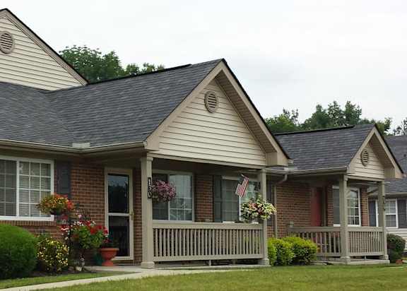 A house with a grey roof and a red door.