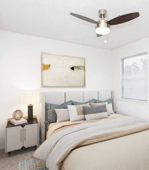 a bedroom with a bed and a ceiling fan