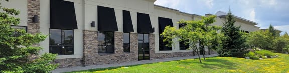a building with black awnings on the windows