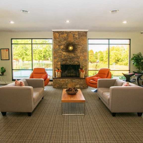A living room with a fireplace and two couches.