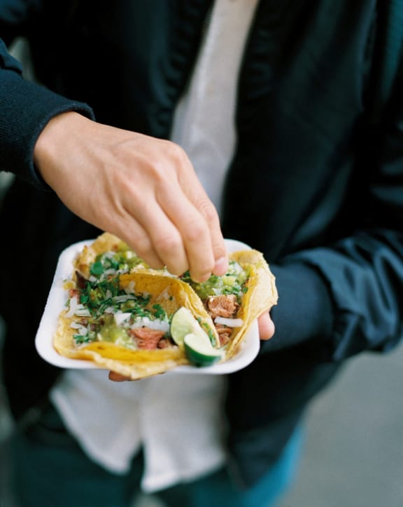 a man holding a plate of food in his hands