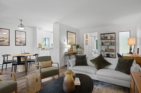 a living room with a couch and a table and a fireplace at The Lakes Apartments in Washington, 98007