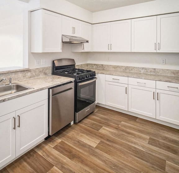 a bedroom with a bed and a ceiling fan  at Black Sand Apartment Homes, Nebraska, 68504