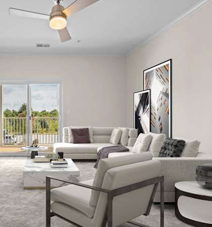 A living room with a flat screen TV, a sofa set, a coffee table, and a ceiling fan.
