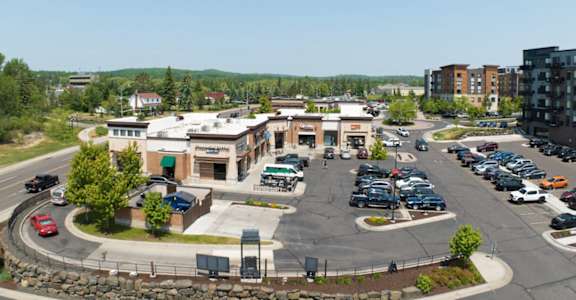 an aerial view of a parking lot and buildings in a city at Bluestone Lofts, Minnesota, 55803